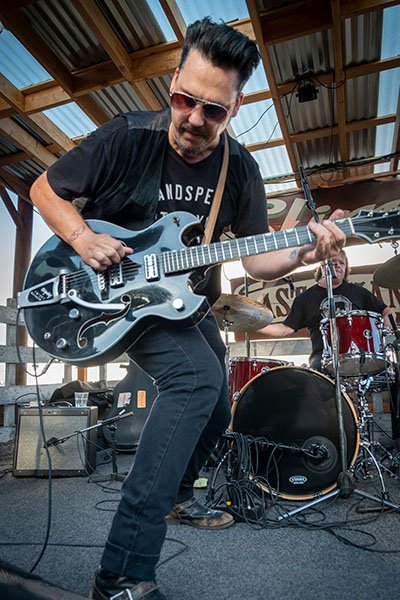 Guitarist and singer performing on stage